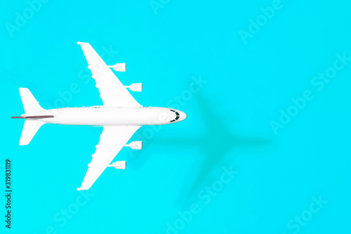Travel minimal background. Model airplane in flight on an empty colored background. Copy space