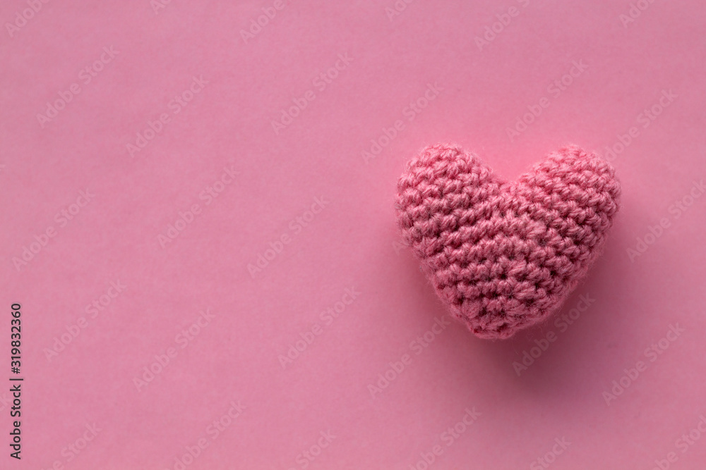 Knitting Pink heart on the and pink abstract background with copy space for text. holiday background. greeting card. top view