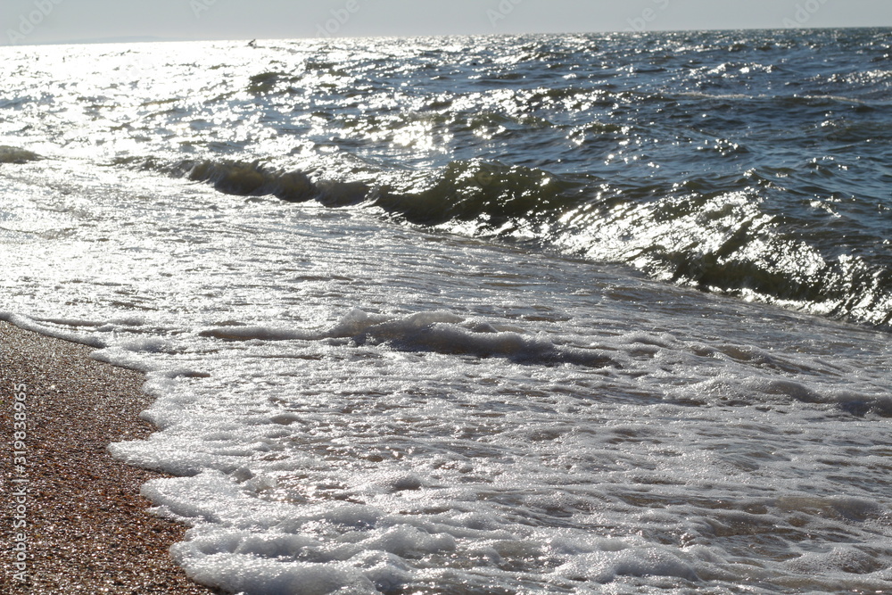 Beautiful splashes of waves on the beach of the sea coast on a bright Sunny day Beautiful splashes of waves on the beach of the sea coast on a bright Sunny day