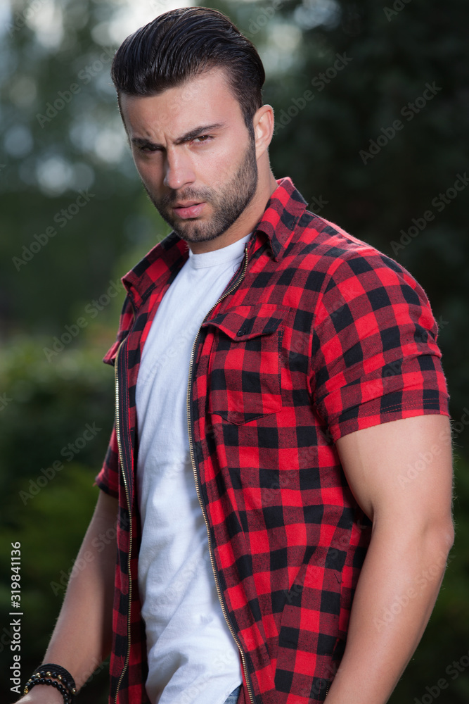 Young elegant handsome man posing outside.
