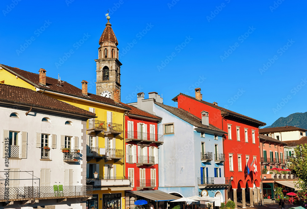Obraz premium St Peter and Paul church tower and facades of buildings at the luxurious resort in Ascona on Lake Maggiore in Ticino canton in Switzerland.