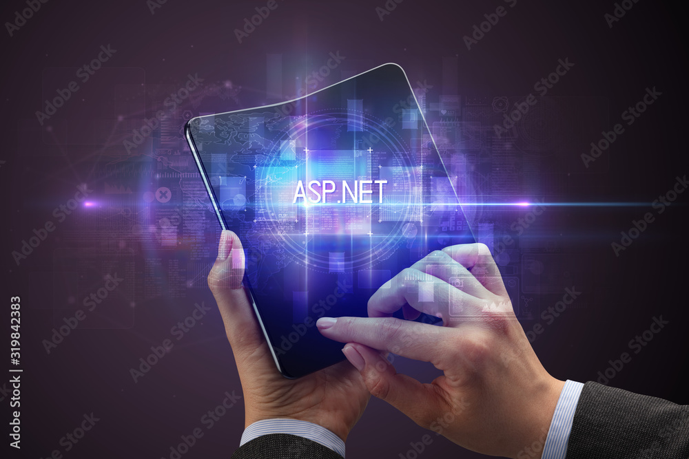Businessman holding a foldable smartphone with ASP.NET inscription, new technology concept Businessman holding a foldable smartphone with ASP.NET inscription, new technology concept