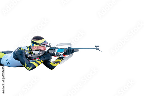 Isolated biathlon skier with rifle in shooting prone position