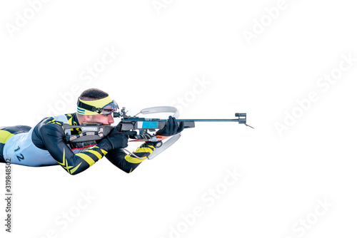 Canvas Print Isolated biathlon skier with rifle in shooting prone position