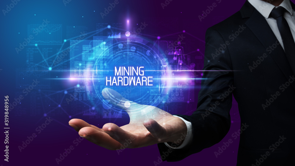Man hand holding MINING HARDWARE inscription, technology concept Man hand holding MINING HARDWARE inscription, technology concept