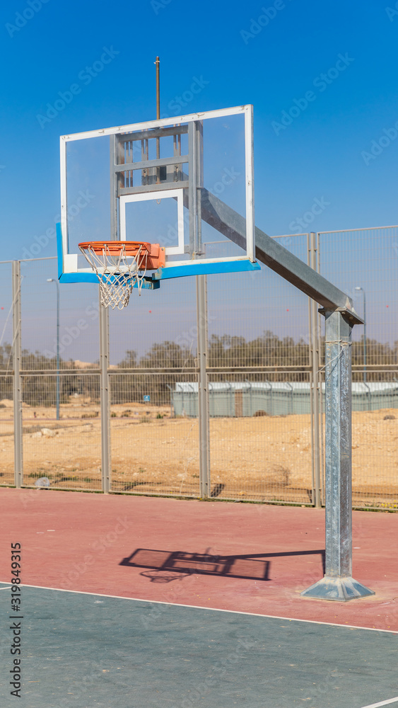 The basketball board front of fence