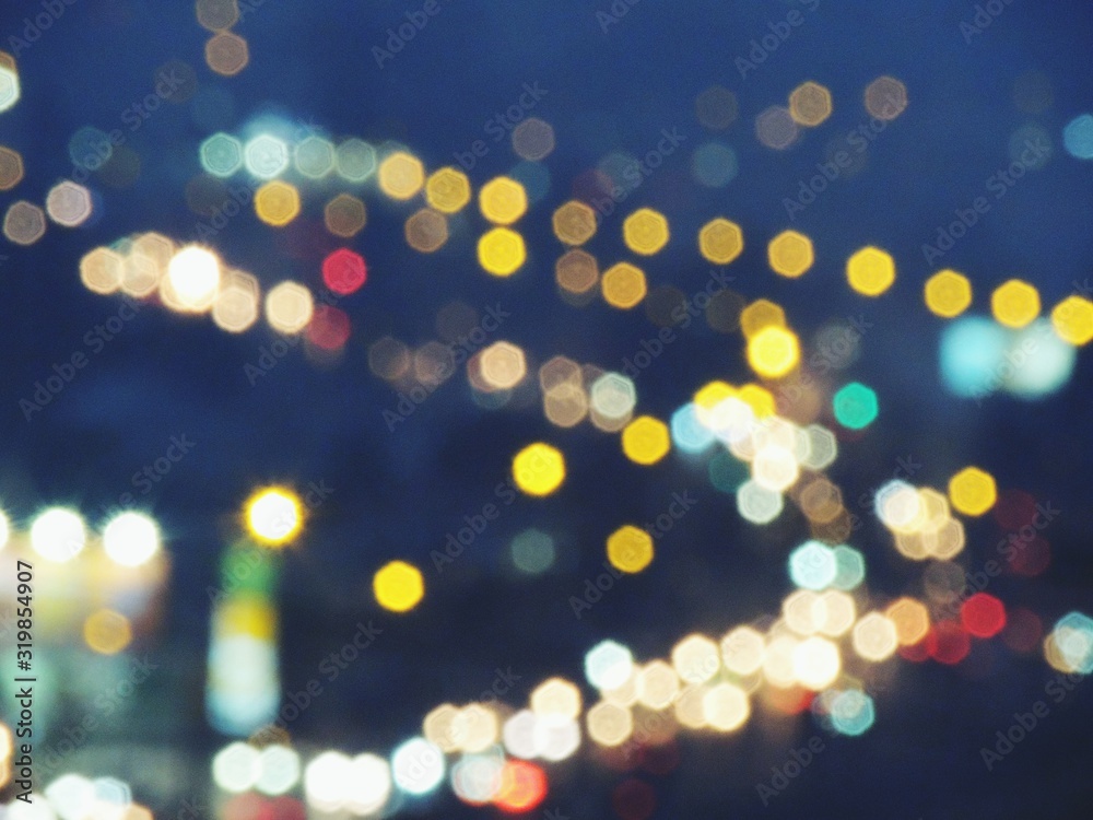 Defocused Image Of Illuminated Cityscape At Night