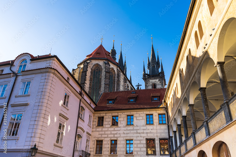 Fototapeta premium Beautiful view of the old streets of Prague, Czech Republic. In the distance you can see the spires of the Church of Mother of God before Tyn. On both sides of the street are buildings with beautiful 
