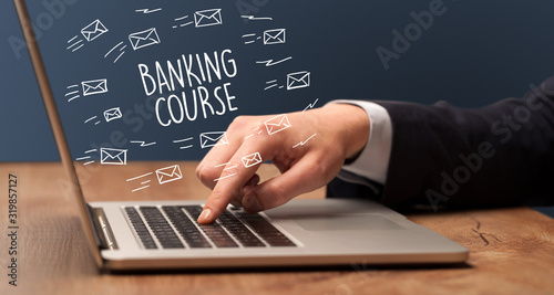 Businessman working on laptop with BANKING COURSE inscription, online shopping concept