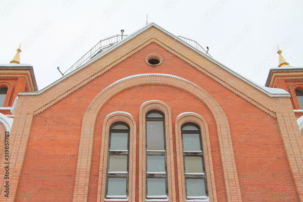 Fragment of a red brick church with windows