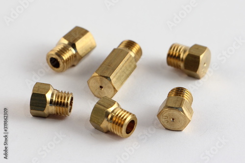 Replaceable gas nozzles for gas stove for different pressure magistral and bottled gas, close up jets on white background