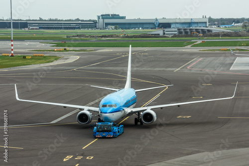 Photography Tractor towing a passenger plane at Schiphol Airport Amsterdam