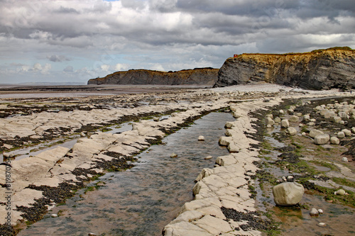 Kilve beach near East Quantoxhead in Somerset, England. Strata of rock dating back to the Jurassic era form cracked pavements along the beach. The area is a paradise for fossil hunters photo