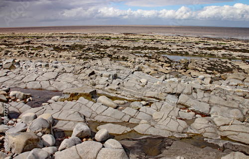 Kilve beach near East Quantoxhead in Somerset, England. Strata of rock dating back to the Jurassic era form huge cracked plateaux along the beach. The area is a paradise for fossil hunters photo