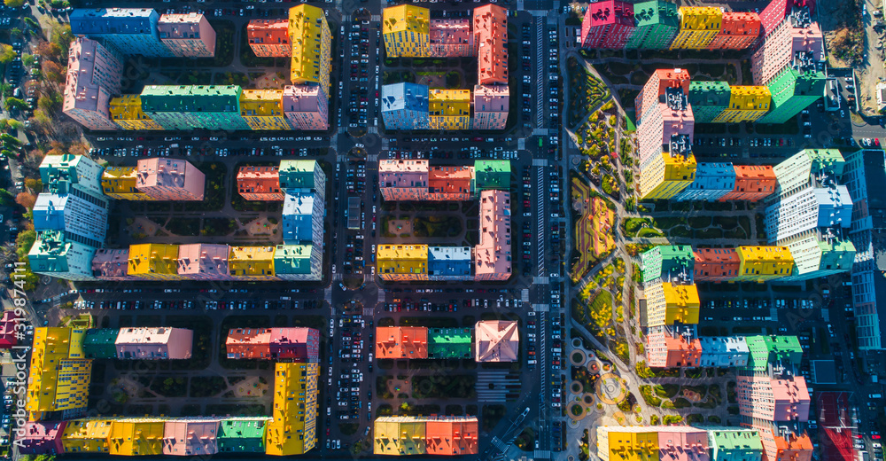 Urban landscape of colorful buildings. Aerial view of the colorful buildings in the European city in the morning sunlight. Cityscape with multicolored houses, cars on the street in Kiev, Ukraine. Urban landscape of colorful buildings. Aerial view of the colorful buildings in the European city in the morning sunlight. Cityscape with multicolored houses, cars on the street in Kiev, Ukraine.