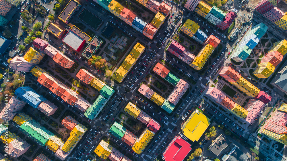 Urban landscape of colorful buildings. Aerial view of the colorful buildings in the European city in the morning sunlight. Cityscape with multicolored houses, cars on the street in Kiev, Ukraine.