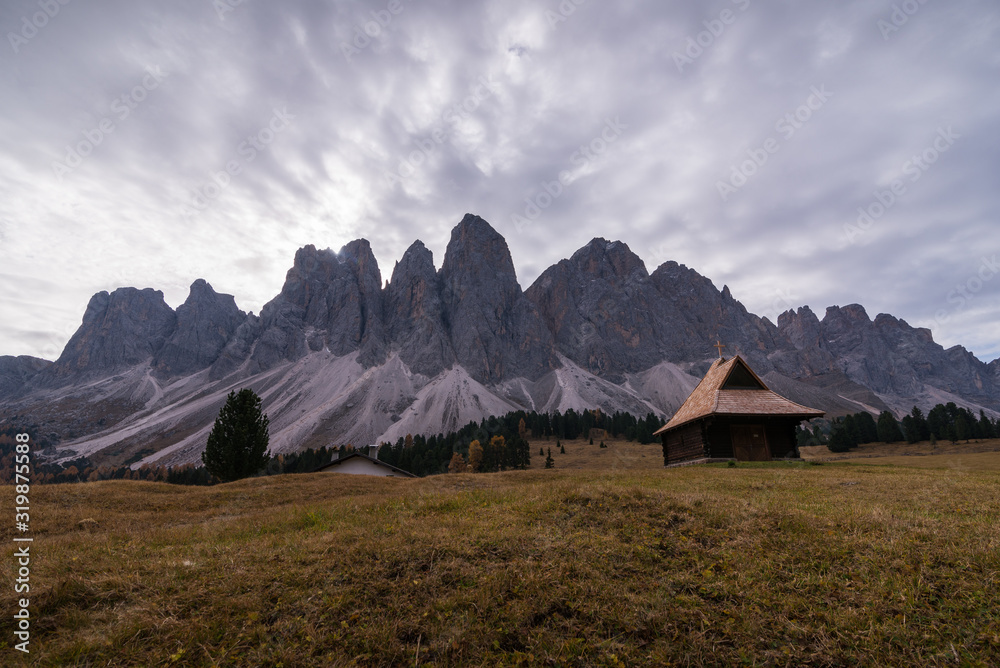 Scenery with small church in alps dolomites in Italy South Tyrol with Sass de Putia mountain on background