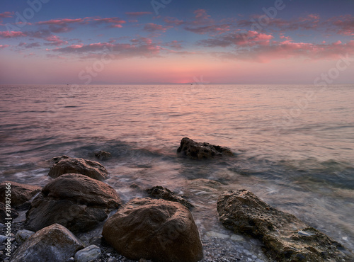 Amazing landscape of sunrise at sea. Colorful morning view of dramatic sky  seascape and rock. Long exposure image. Greece. Mediterranean Sea. Concept of nature background.