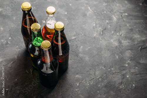 Bottles of beer in different colors. Light and dark beer. Beer background for advertising, chilled drink