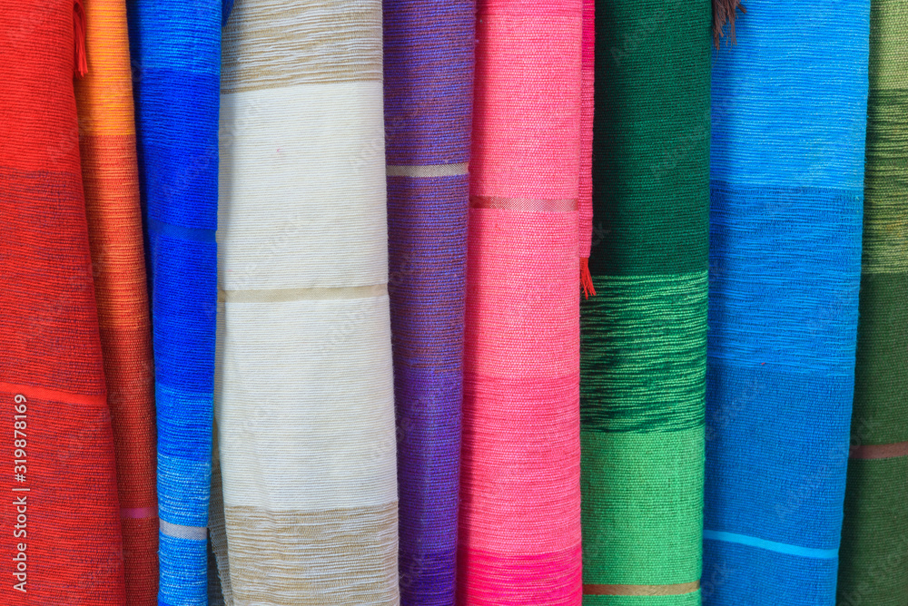 Pieces of fabric and textiles in a factory shop. Multi different colors and patterns on the market. Pieces of fabric and textiles in a factory shop. Multi different colors and patterns on the market.