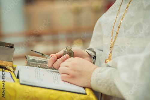 Bilde på lerret priest holds in his hands a bottle with miro and a brush for making anointing on