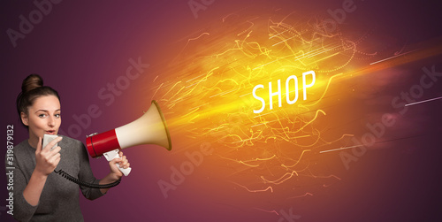 Photography Young girld shouting in megaphone with SHOP inscription, online shopping concept