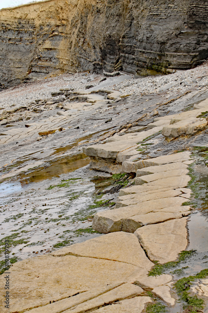 Rocks on Kilve beach near East Quantoxhead in Somerset, England. Stratified layers of rock date back to the Jurassic era and are a paradise for fossil hunters. Rocks on Kilve beach near East Quantoxhead in Somerset, England. Stratified layers of rock date back to the Jurassic era and are a paradise for fossil hunters.