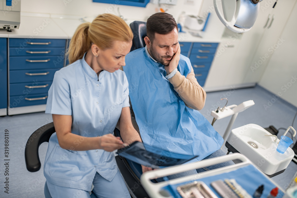 Dentist and patient looking to x-ray Dentist and patient looking to x-ray