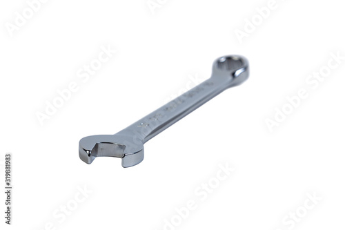 Silver wrench lies on a white isolated background