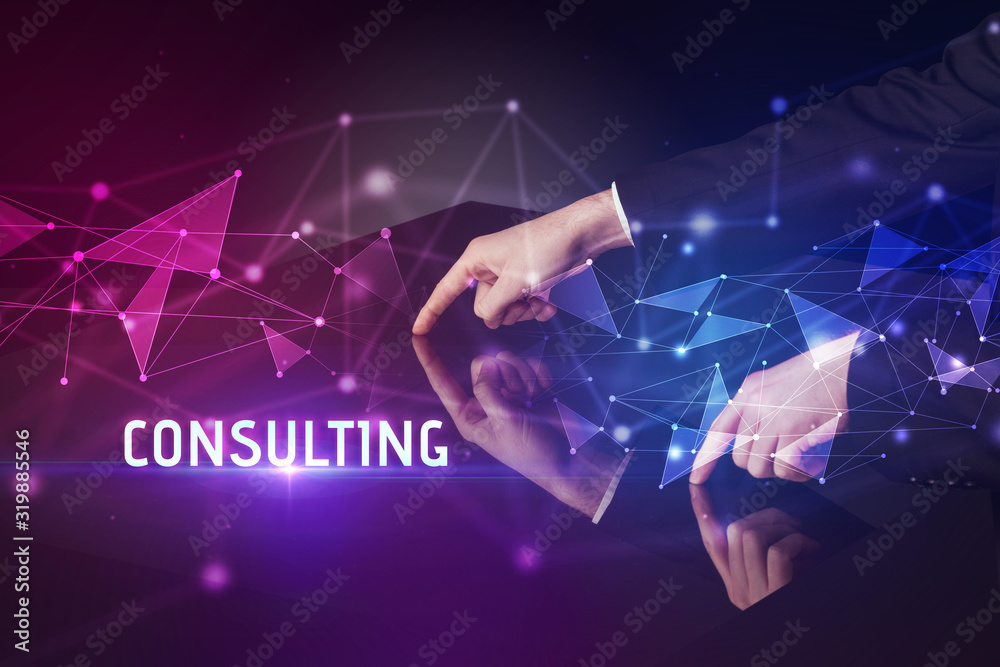 Businessman touching huge screen with CONSULTING inscription, modern technology business concept Businessman touching huge screen with CONSULTING inscription, modern technology business concept