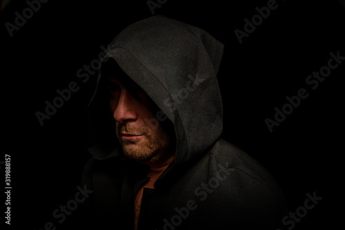 Portrait of a courageous warrior wanderer in a black cloak. Historical fantasy. Halloween