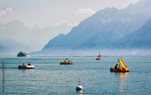Lausanne, Switzerland - August 26, 2016: People in catamarans on Lake Geneva in Lausanne, Switzerland