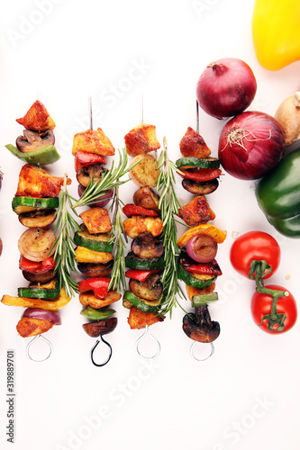 Grilled pork shish or kebab on skewers with vegetables . Food background shashlik © beats_