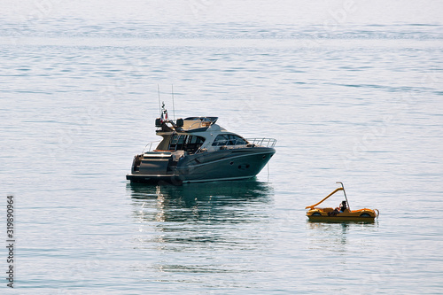 Cruise ship and people in catamaran on Lake Geneva in Lausanne, Switzerland