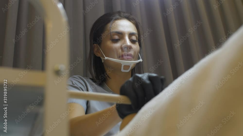 the beautician smiles and passes the girl with a stick with rich nitrogen from which there is steam