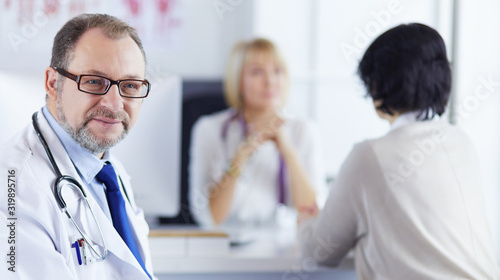 Smiling medical doctors on a workplace in hospital