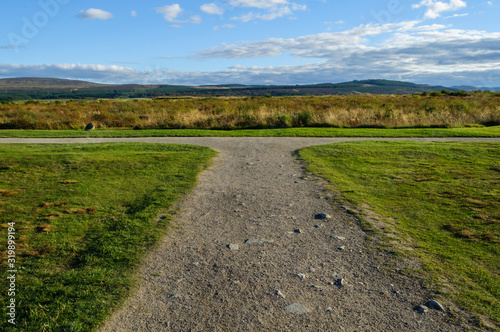 Concept of choice   footpath forks left or right and is pictures on a summer day at Drummossie Moor near Inverness in the Scottish Highlands  the site of the Battle of Culloden in 1746