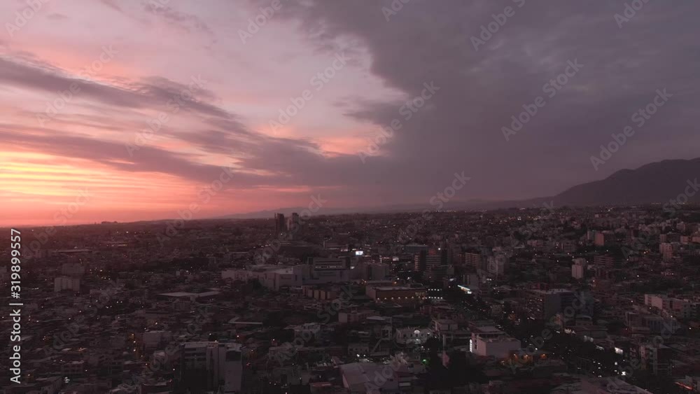 Sunset over Arequipa Peru. City with sillhouette background. Buildings in black, with sun setting. Pink, red, orange sky. Dramatic panoramic. Sunset over Arequipa Peru. City with sillhouette background. Buildings in black, with sun setting. Pink, red, orange sky. Dramatic panoramic.