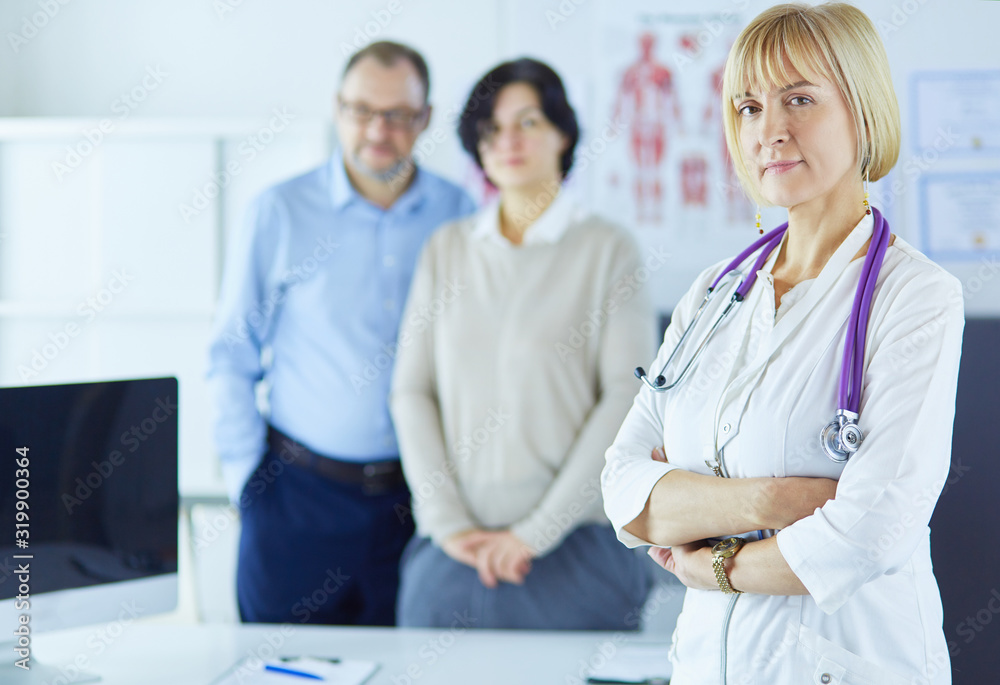 Smiling medical doctor with stethoscope and elderly couple Smiling medical doctor with stethoscope and elderly couple