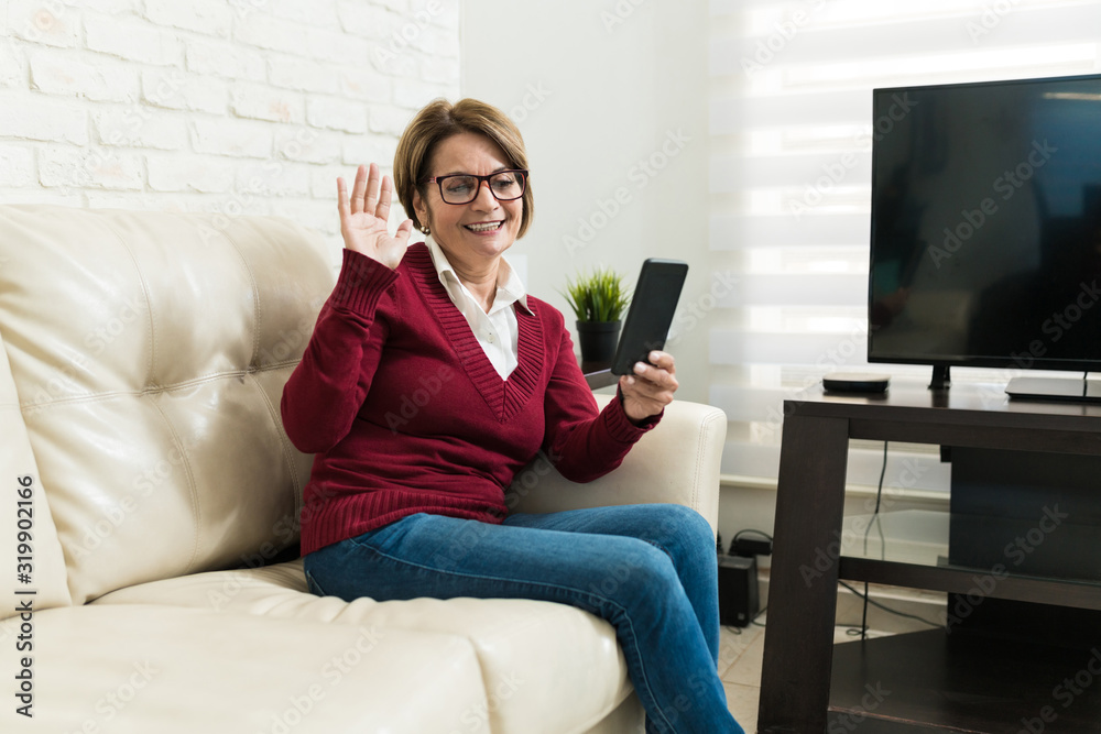 Retired Woman Using Smartphone At Home Retired Woman Using Smartphone At Home