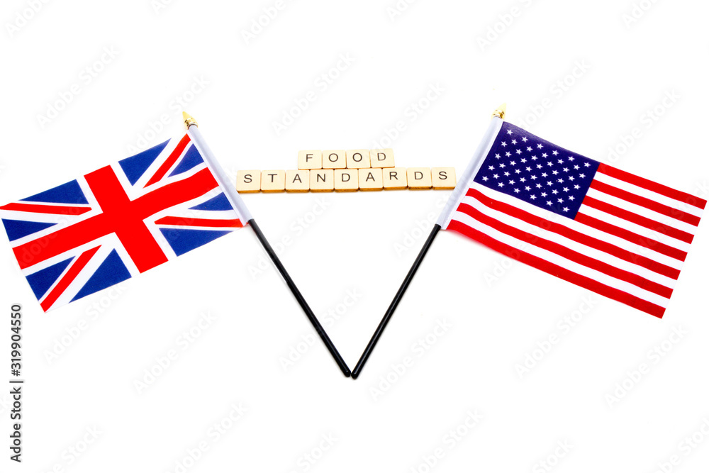 The flags of the United Kingdom and the United States isolated on a white background with a sign reading Food Standards The flags of the United Kingdom and the United States isolated on a white background with a sign reading Food Standards