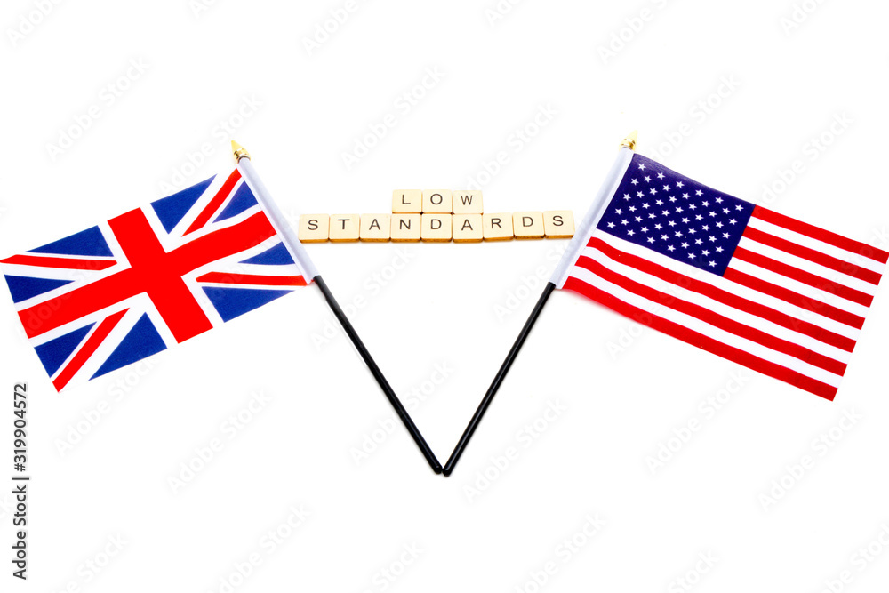 The flags of the United Kingdom and the United States isolated on a white background with a sign reading Low Standards The flags of the United Kingdom and the United States isolated on a white background with a sign reading Low Standards