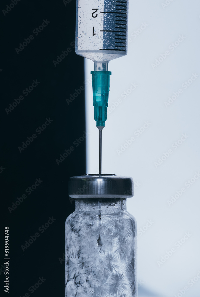 Medicine, Injection, vaccine and disposable syringe, drug concept. Sterile vial medical syringe needle. Macro close up. Glass medical ampoule vial for injection. Bottles ampule with aluminum cap.