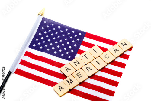 The flag of the United States isolated on a white background with a sign reading Anti American photo