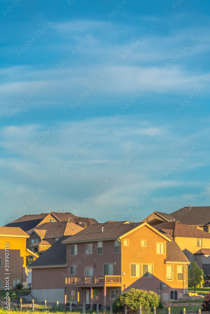Beautiful landscape of houses and vast cloudy sky viewed on a bright sunny day