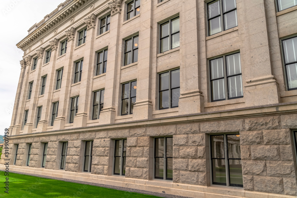 Fototapeta premium Building facade with decorative mouldings on the white stone exterior wall