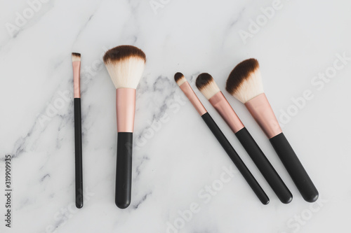 beauty industry and make-up products, variety of make-up brushes for face and eyes on marble tabletop