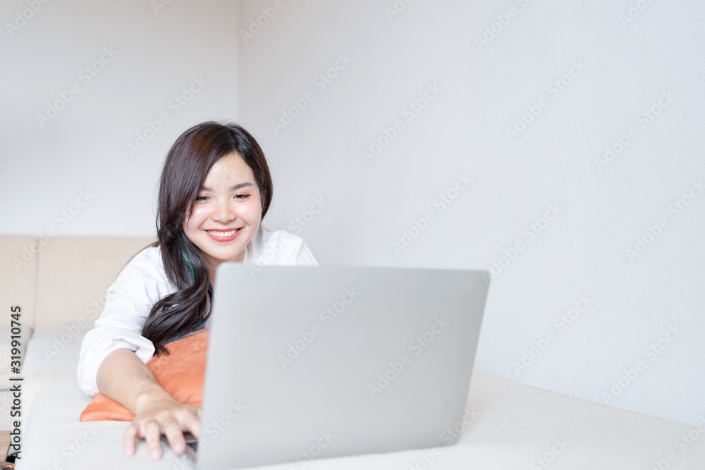 Charming teenage lying on bed and watching tv or movies streaming on laptop. Charming teenage lying on bed and watching tv or movies streaming on laptop.