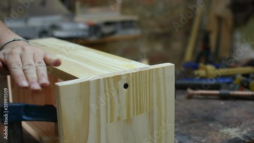 close up woman carpenter using a little wood planer on a wood box