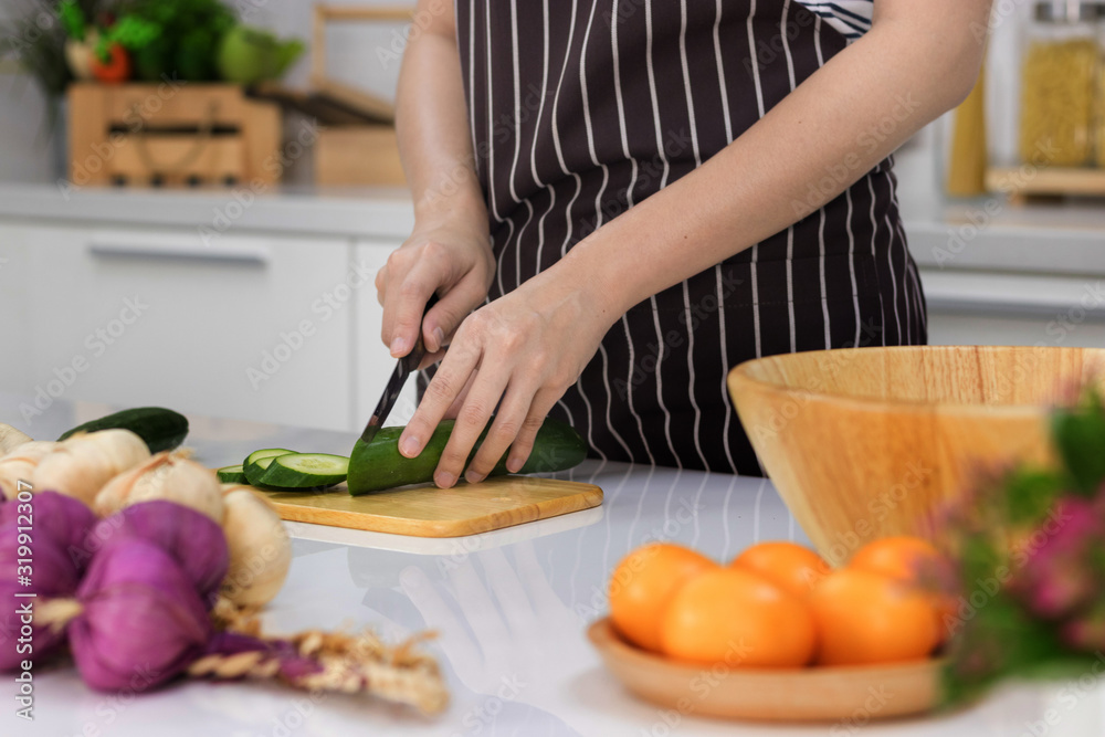 Healthy food. Woman preparing Sliced tomatoes and vegetables